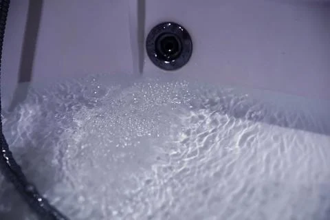 Soap bubbles background. Shampoo foam in the water in the bathroom. Jacuzzi.. Stock Photos