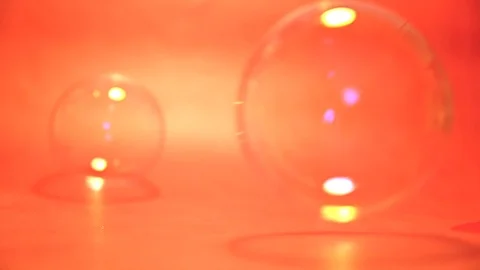 Soap bubbles balls falling on orange iridescent background Stock Footage 104900739