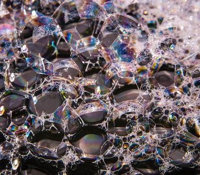 Soap bubbles on a black background, close-up, copy space, macro, pattern, tex Foto stock