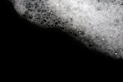Soap bubbles on a black background. Stock Photos