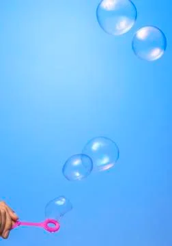 Soap bubbles on blue background Stock Photos