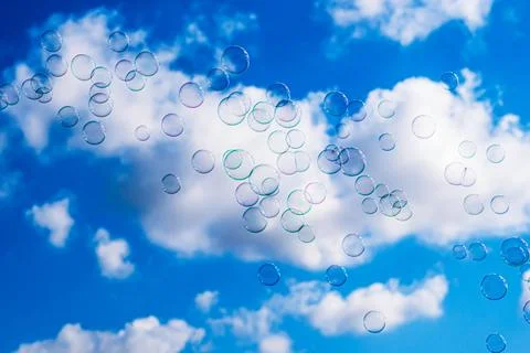 Soap bubbles on blue cloudy sky background Stock Photos