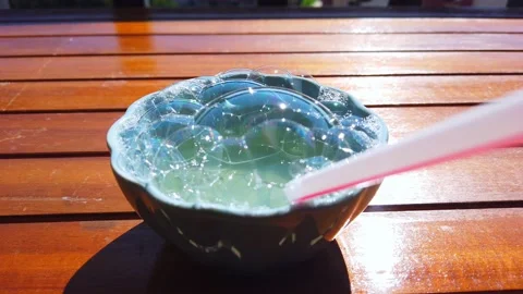 Soap bubbles in cup. Large straws inflate large soap bubbles from soap solution Stock Footage 134050270