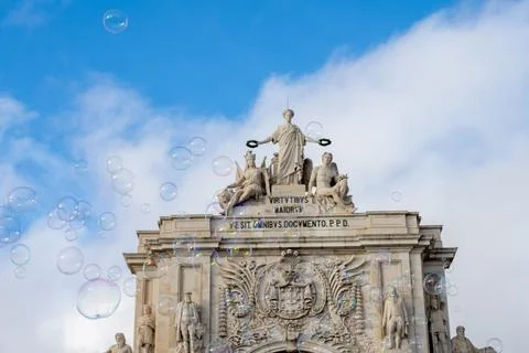 Soap bubbles drifting above Praca do Comercio arch Stockfoto's
