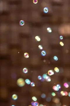Soap bubbles float against a blurred outdoor scene. Colorful playful backgr.. Stock Photos