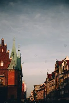 Soap bubbles float over red brick spires of a town Stock Photos