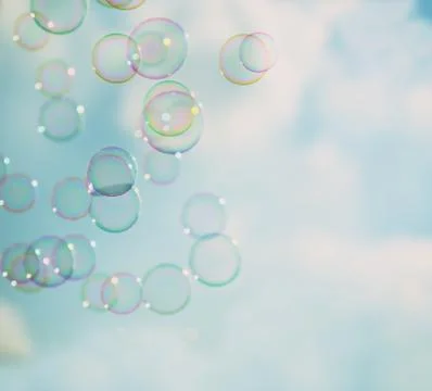 Soap bubbles floating in the air aginst sky Stock Photos