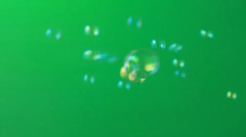Soap bubbles floating around shooting with high speed camera on green background Stock-Footage 55410261