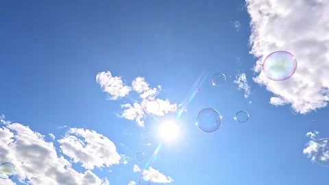 Soap bubbles floating under bright blue summer sky Video stock 321437894