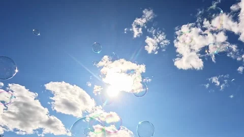 Soap bubbles floating under sunny sky with clouds Stock Footage 319571114