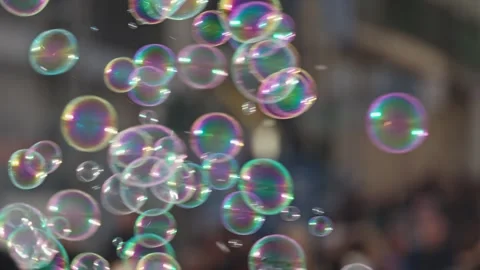 Soap bubbles floating in urban setting with crowd Stock Footage 305923212