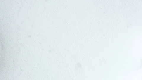 Soap bubbles flowing down. Macro shot of white soap suds. Shower concept. Stock Footage 269324756