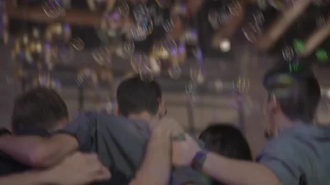 Soap bubbles fly in the air above the heads of people dancing at a party Video stock 226209973