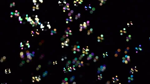 Soap bubbles fly and fade in different colors. Slow motion. Black background Stock Footage 98001867