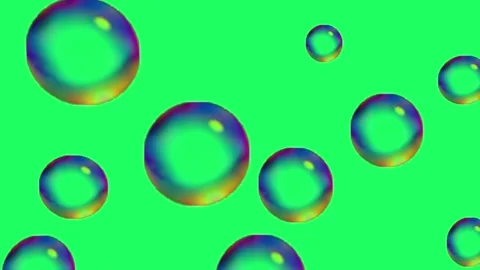 Soap bubbles flying on the green background Stock Footage