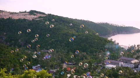Soap bubbles flying over the sea and the mountains. panoramic view Vidéo 74768300