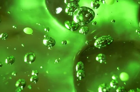 Soap bubbles on green background, abstract background. Stock Photos
