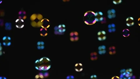 Soap bubbles isolated on black background. Holiday backdrop with flying bubble 스톡 동영상 334454185