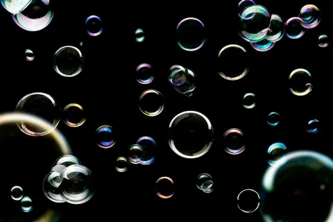 Soap bubbles isolated on black background Stock Photos