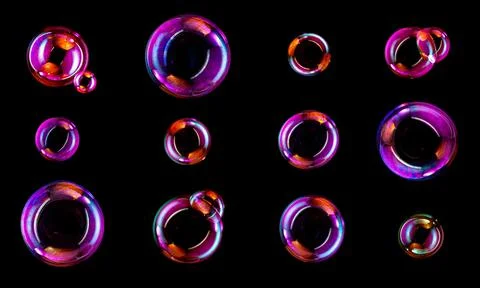 Soap bubbles isolated on black background . Stock Photos
