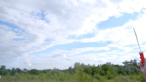 Soap bubbles in nature. Blowing soap bubbles outdoors. Soap bubble against the Stock Footage 279271524