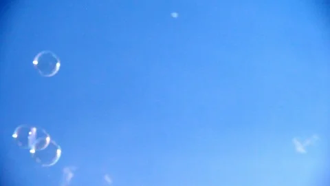 Soap bubbles overhead in the sky Stock Footage 107936994