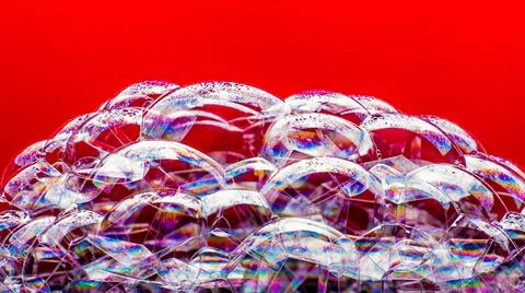 Soap bubbles on a red background, close-up, copy space, macro, pattern, textu Foto stock