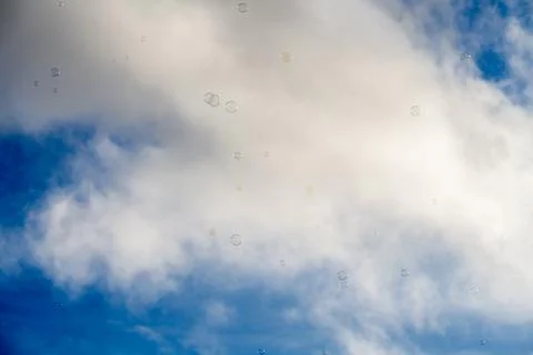 Soap bubbles rising in front of yellow facade in Lisbon square Stock Photos
