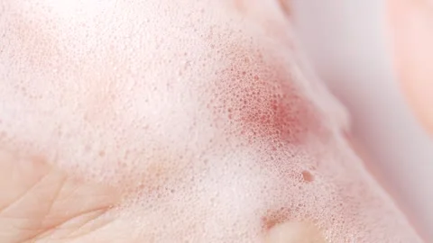 Soap bubbles on skin of hand, macro. Female hands are washing with soap bub.. Stock Footage 305513100