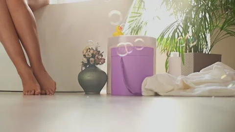 Soap bubbles slowly fall to the bathroom floor on a Sunny morning Stock Footage 153163023