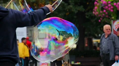 Soap bubbles on the street, huge bubble flying near people Stock Footage 43682047