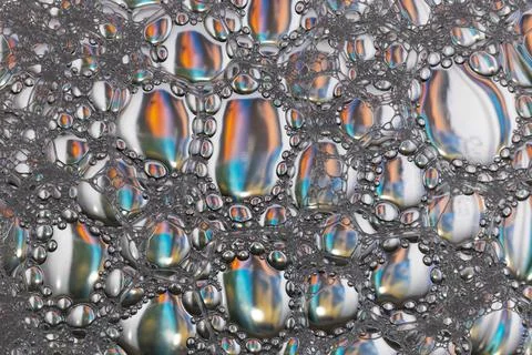 Soap bubbles on the water abstract background. Stock Photos