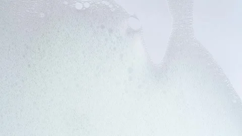 Soap bubbles on window glass. Macro shot of white soap suds flowing down of.. Stock Footage 271230554