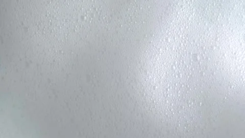 Soap bubbles on window glass. Macro shot of white soap suds flowing down of.. Stock Footage 275143840