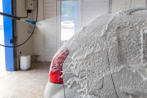 Soap detergent foam application process while washing indoors at self-service Stock Photos