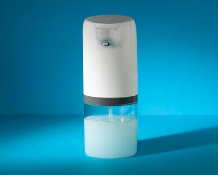Soap dispenser automatic. Close-up. Blue background. Stock Photos