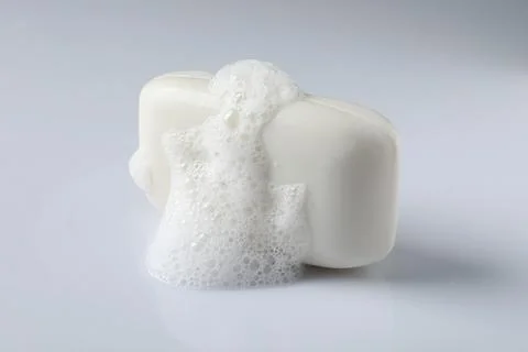 Soap with fluffy foam on white background Foto stock