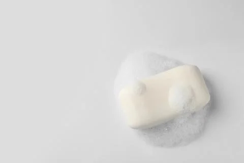 Soap with fluffy foam on white background, top view Foto stock
