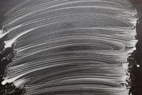 Soap foam on a black table. Foam traces on black background. Stock Photos