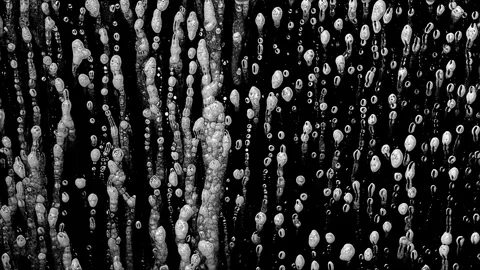 Soap Foam Bubbles Dripping Down Glass, Black and White Close-Up Stock Footage 346079477