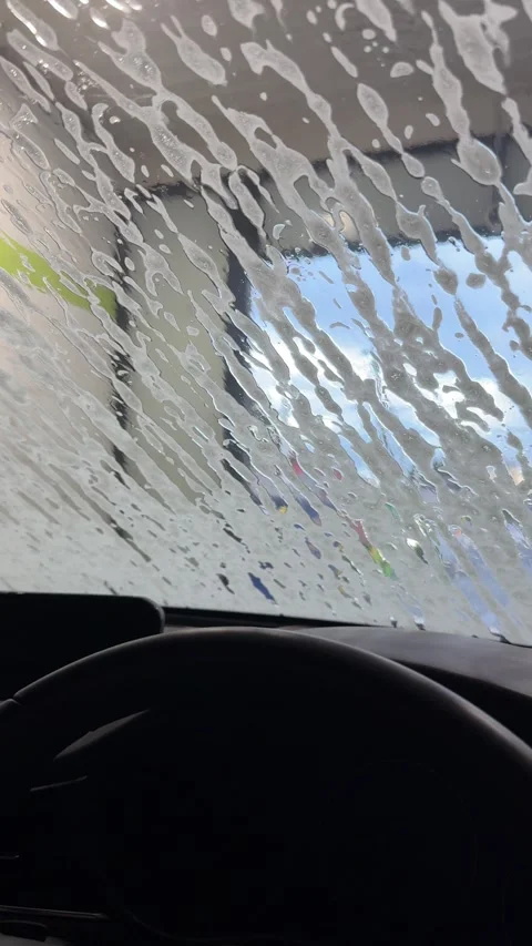 Soap Foam Streaming Down Car Windshield During Automatic Car Wash Stock Footage 340678963