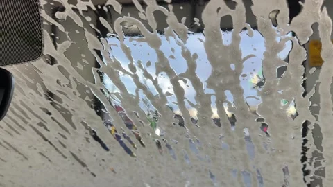 Soap Foam Streaming Down Car Windshield During Automatic Car Wash Stock-Footage 340680401