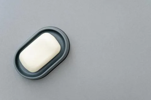 Soap in gray soap dish, flat lay, mockup, top view, space for text. Stock Photos