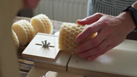 A soap maker cuts a round handmade honey soap on a wooden cutter Stock Footage 277873203