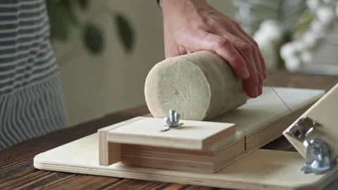 Soap maker cuts a round handmade soap on a wooden cutter.  Stock Footage 277873250