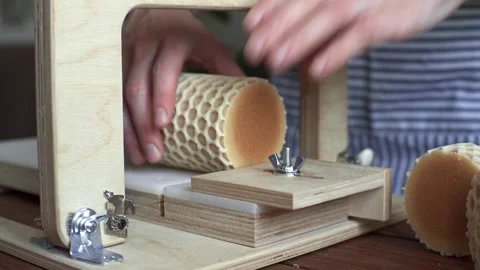 A soap maker cuts a round handmade honey soap on a wooden cutter Stock Footage 277876426