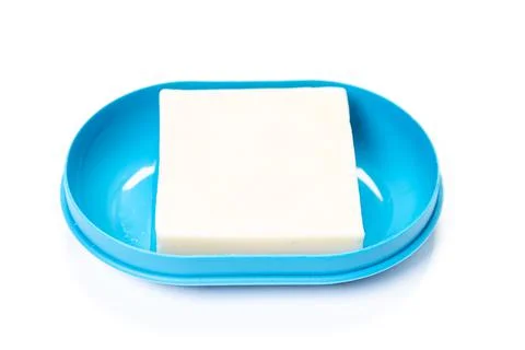 Soap in PLASTIC COLORED soap dish isolated on white background Stock Photos
