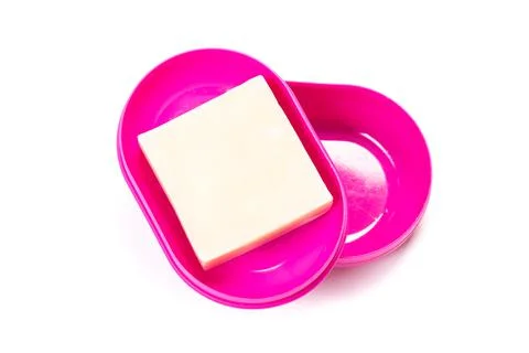 Soap in PLASTIC COLORED soap dish isolated on white background Stock Photos