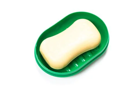 Soap in PLASTIC COLORED soap dish isolated on white background Foto stock