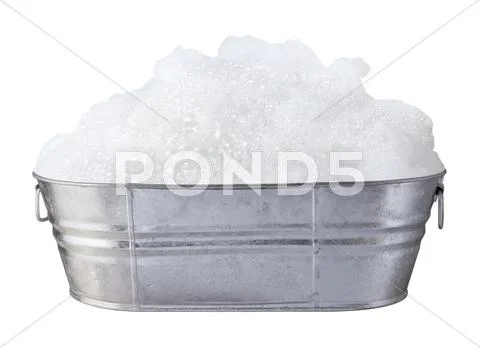 Soap suds and bubbles in a tub isolated Stock Photos